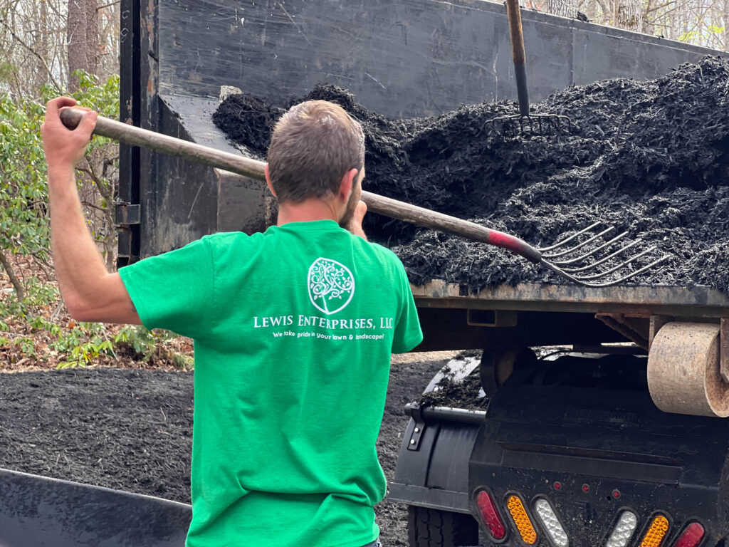 A landscaper installing mulch.